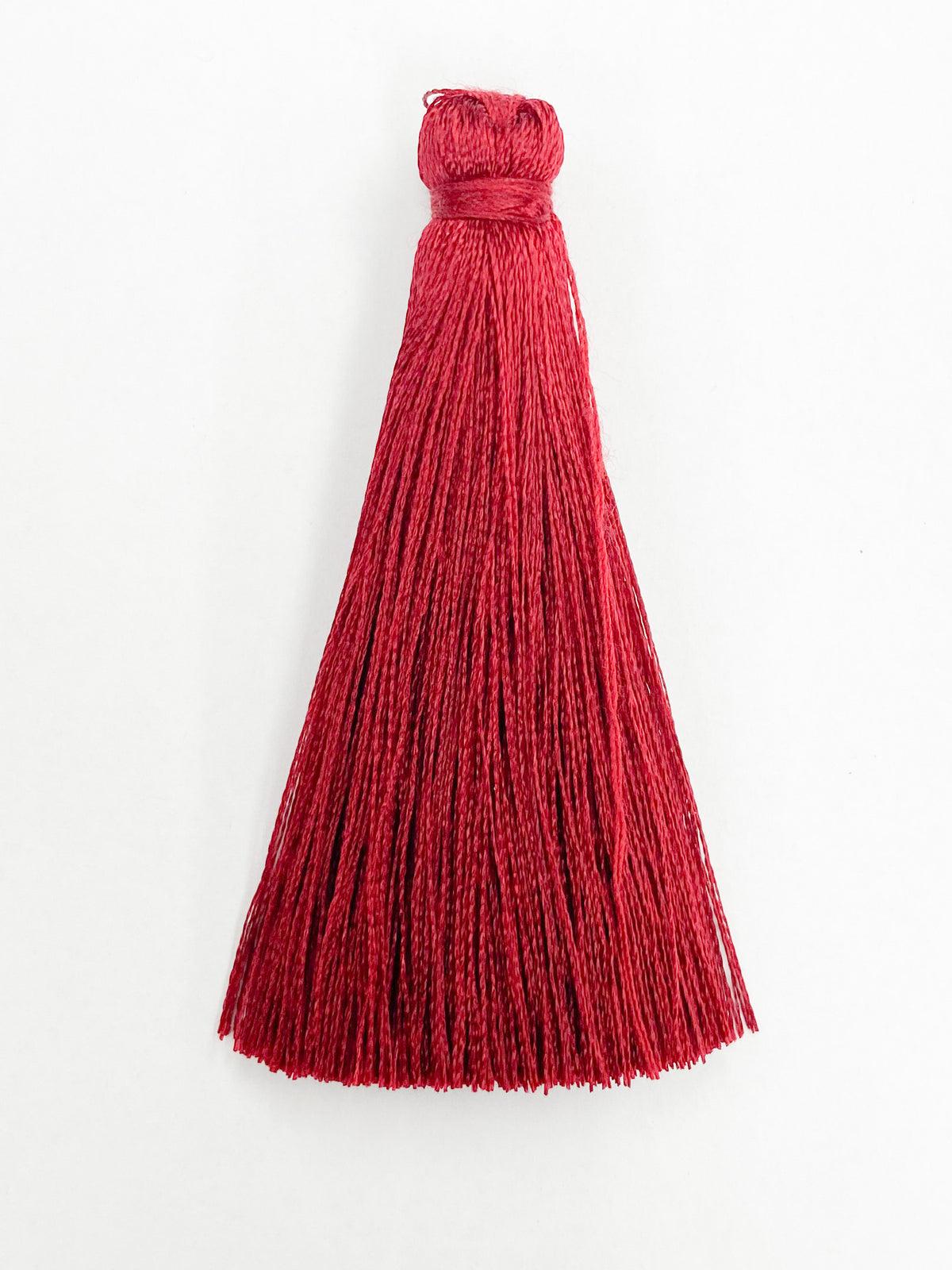 Dark Red Coloured Tassel, 65mmL x 10mm. Polyester fibre.