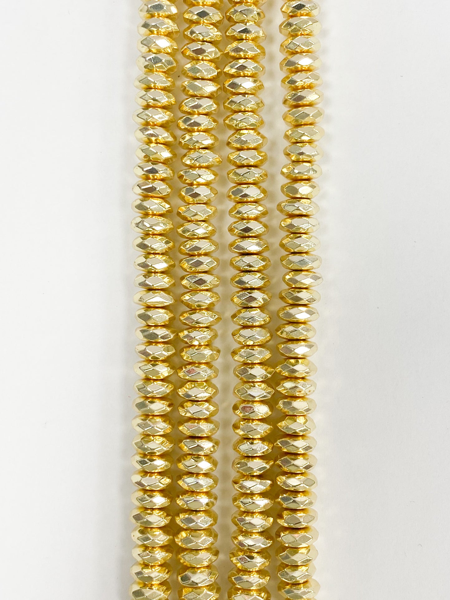 6mm x 3.2 mm Hematite Faceted Rondelles. Approx 15.5" Strand Yellow Gold Colour
