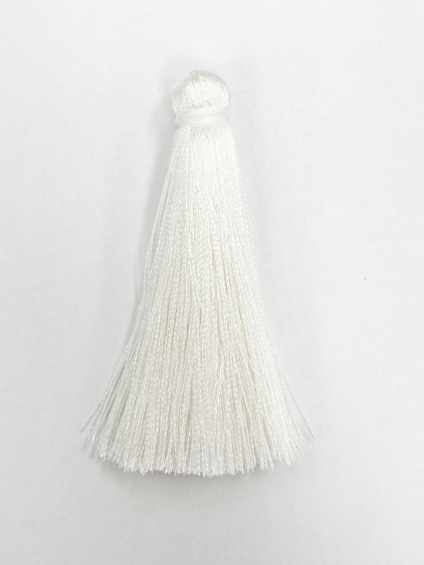 White Coloured Tassel, 65mmL x 10mm. Polyester fibre.